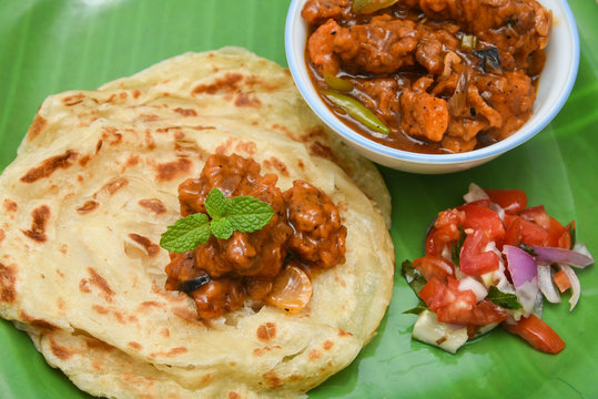 Kerala parathas / porotta / roti / parotta / barotta/ naan layered flatbread made from maida or whole wheat flour. Eat with spicy Asian chicken or beef or egg curry gravy. breakfast dish. Indian food.