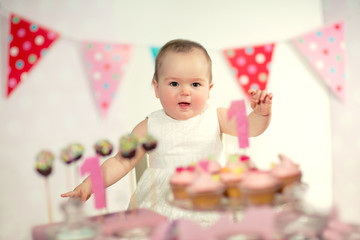 Beautiful happy baby on first birthday background.
