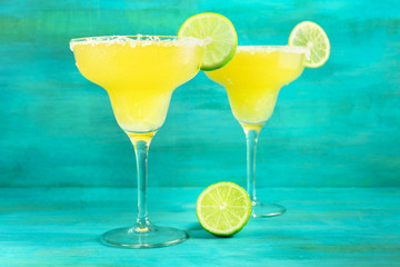 Lemon Margarita cocktails on vibrant turquoise with copyspace