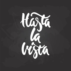 Hasta la vista - hand drawn spanish lettering phrase, that means See you on the black chalkboard background. Fun brush ink inscription for photo overlays, greeting card or t-shirt print, poster design