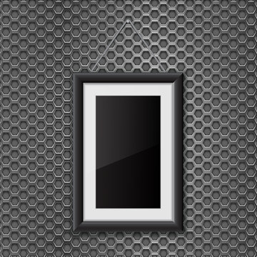 Empty black photo frame on metal perforated background