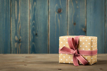 Polka dot gift box on wooden table