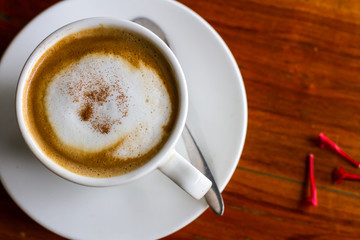 Hot coffee in cup on wooden table