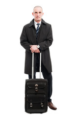 Middle age business man standing with carry on luggage