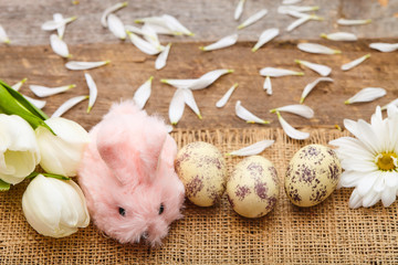 Easter composition with eggs, flowers and toy hare