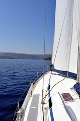Ultramarine blue water and land viewed from deck of yacht: The blue waters of the turquoise coast in Turkey and land as viewed from the deck of a sailing yacht.