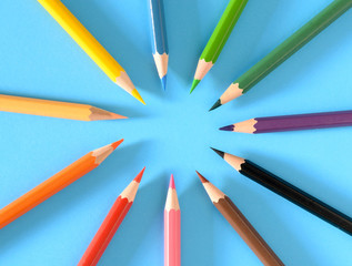 Multicolored pencils isolated on blue background
