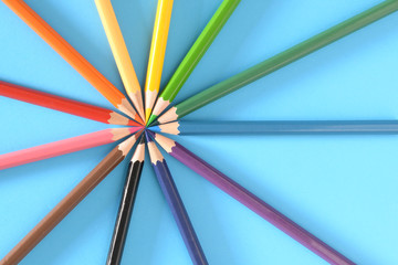 Multicolored pencils isolated on blue background
