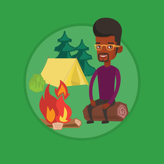 Fototapeta premium Man sitting on log near campfire in the camping.