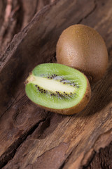 Kiwi fruit and half kiwi fruit on wooden background, Selective focus