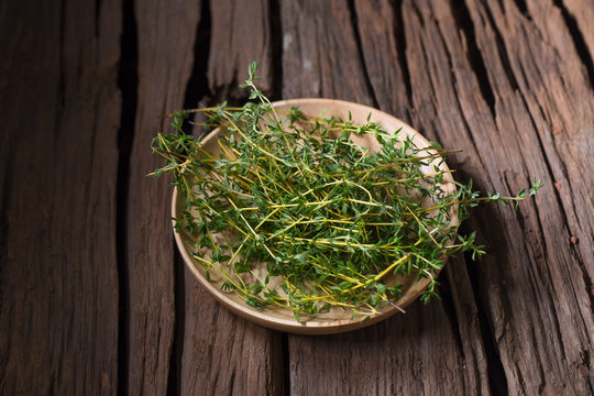 Thyme fresh herb on old wood background