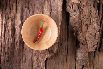 Red hot chili peppers in Wooden bowl on wooden background. Spicy chilli peppers