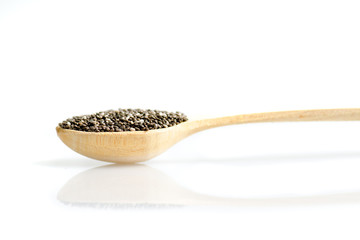Chia seeds in wooden long spoon with reflexion isolated on white