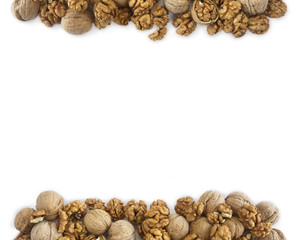 Walnuts background. Walnuts at border of image with copy space for text. Kernels walnuts on a white background. Top view.