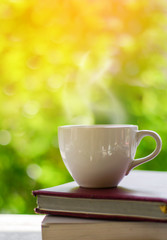 Cup of coffee on nature background.