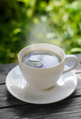 Cup of coffee on nature background.