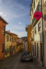 Fototapeta na wymiar Narrow street with colourful old houses in Porto