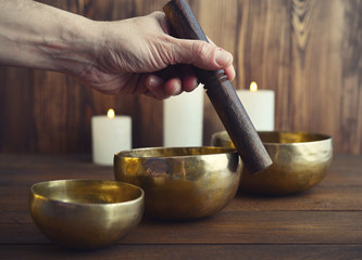 Male playing on Tibetan singing bowls