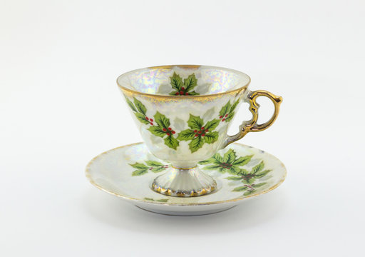 Tea cup and saucer with Christmas holly printed