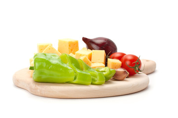 Cheese and a set of vegetables isolated on white background