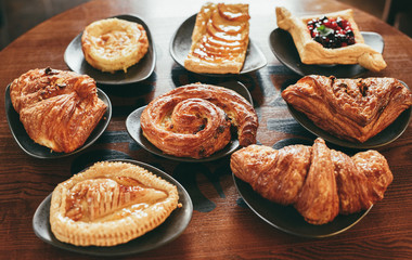 Variety of puff pastry buns on the table - 142324957
