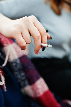 Hand of girl with cigarette. Stop smoking social problem.