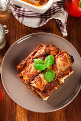 Baked cannelloni with minced meat and bechamel sauce on a plate
