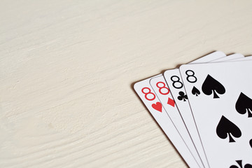 four eight poker hands playing cards on a light desk background. Game luck abstract. Gambling game for people. Copyspace.
