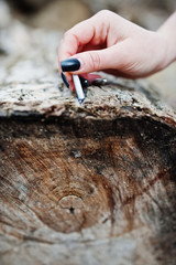 Hand of girl with extinguished cigarette on stump. Stop smoking social problem.