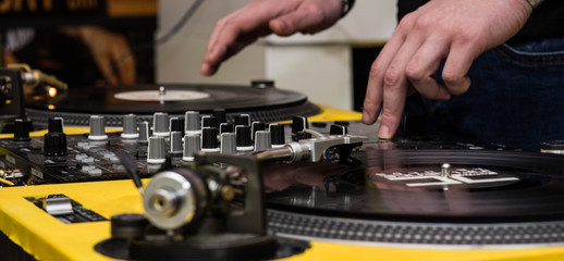 DJ play vinyl in turntables and mixer
