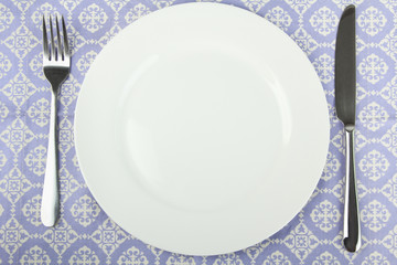 White plate, fork and knife