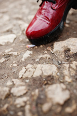 Leg of girl with extinguished cigarette on ground. Stop smoking social problem.