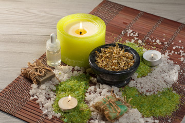 Obraz na płótnie Canvas Spa nature products. Sea salt, chamomile, soap and aromatic oil on wooden background