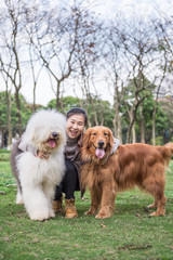 Girl and dogs, outdoors on the grass