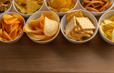 Pretzels in bowls on wooden table from above