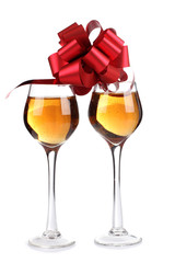 Wine glasses and a red ribbon on white background