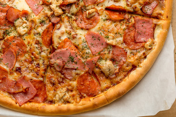 Pizza close up photo, meat ingredients: ham, bacon, chicken breast, delicious 