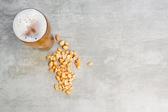 Glass of beer and peanuts