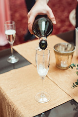 someone pouring wine into glass in detail