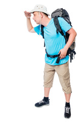 Man with a backpack in full length looking into the distance on a white background