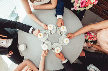 People holding in hands cups with coffe.