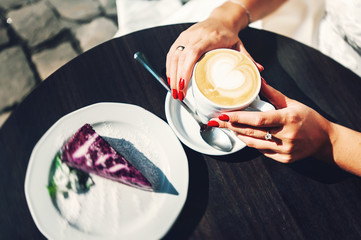married woman drinking coffee at the cafe patio at the sunrise