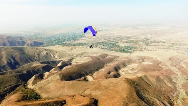 Paraplane, paraglider in the air aerial shot HD slow motion 50FPS