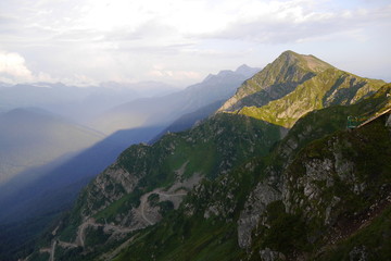 Mountain peak casting a shadow at sunset in Rosa Khutor