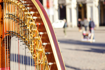 Part of musical instrument called harp in abstract background .