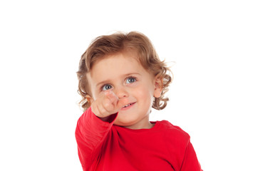 Adorable baby with red shirt pointing with his finger