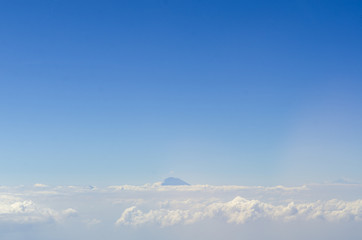 alpine landscape with peaks covered by snow and clouds