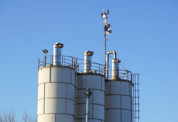 Silver Grain Silos with blue sky in background