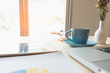 Image of coffee on desk of working businesspeople at meeting