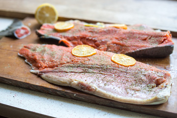 Raw salmon on cutting board, ready for cook